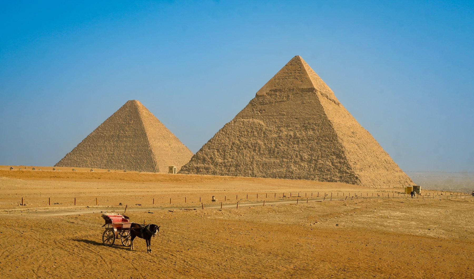 Two pyramids and a carriage on the Giza plateau